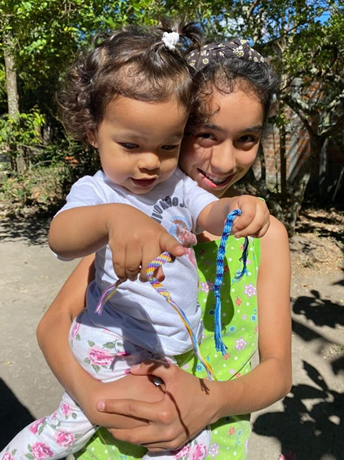 El Salvadorian children with bracelets made by OPhiA